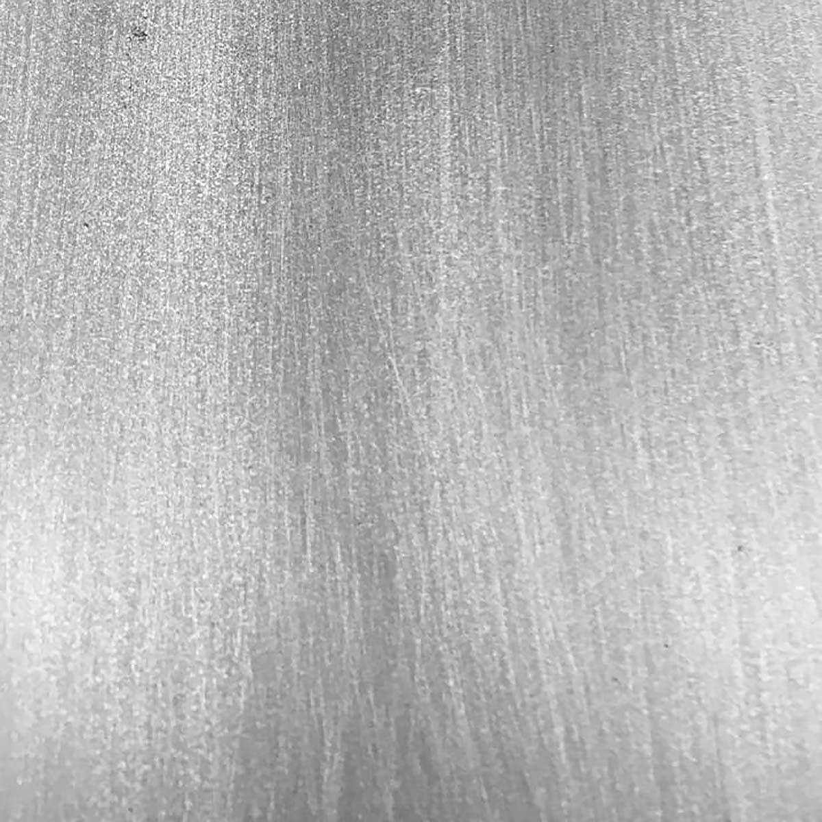 Close-up of iron range hood finish with riveted straps, flared collar, and hand-forged surface texture