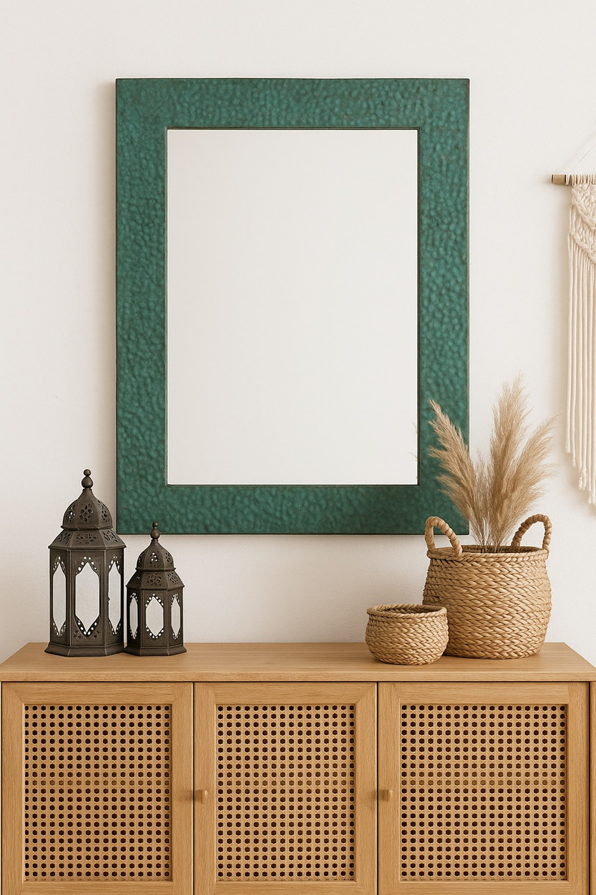 Hammered green copper mirror in eclectic Bohemian room over a sideboard with Moroccan lanterns and woven baskets