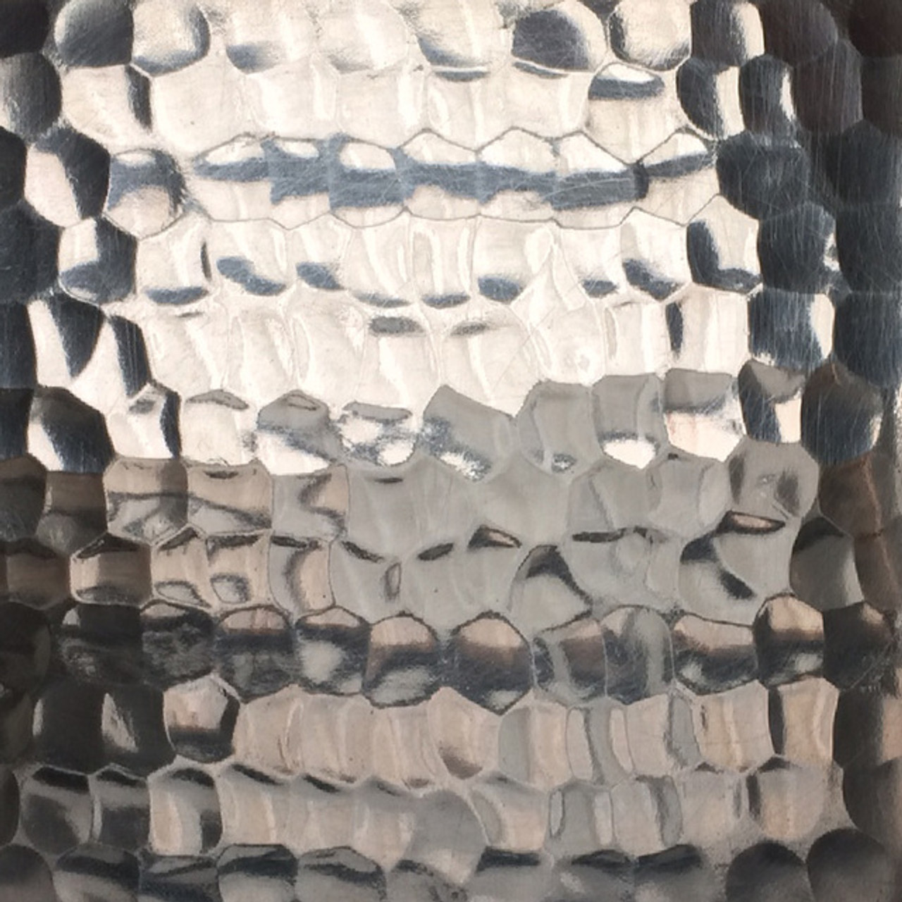 Reflective hammered pewter with artisanal detailing