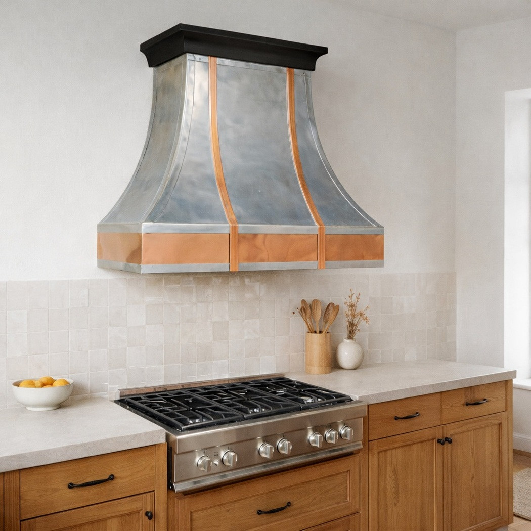 Polished zinc range hood with copper straps and apron in a transitional kitchen with a Scandinavian flavour