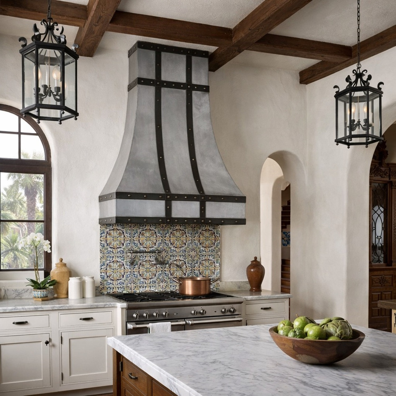 Spanish kitchen with brushed zinc range hood, darkened zinc straps, and boxed apron
