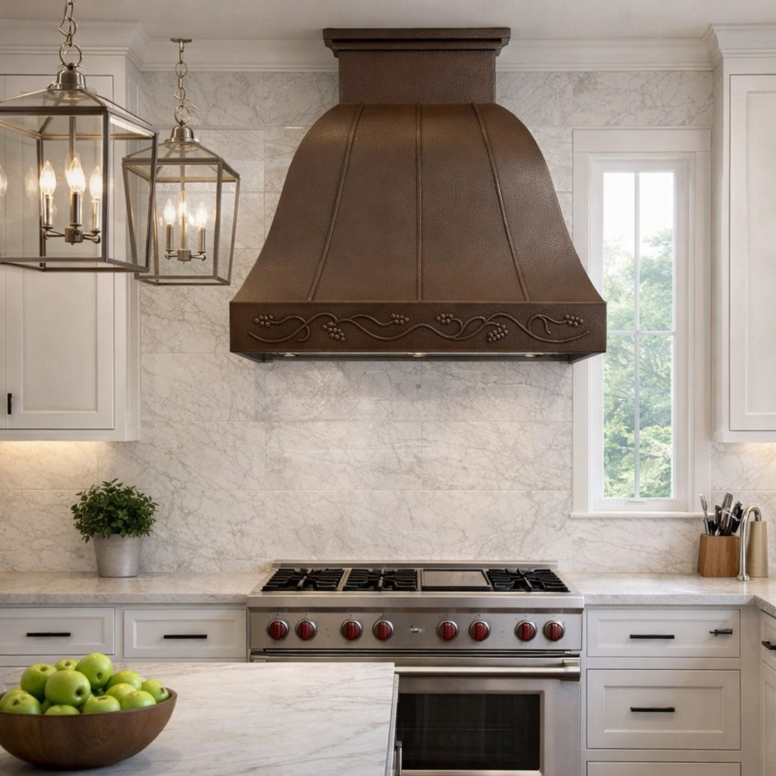 Copper range hood with a floral motif in a transitional kitchen with classic ornament with clean lines, neutral cabinetry and warm backsplash