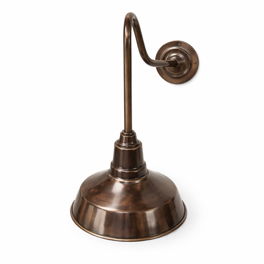 Brass gooseneck wall sconce with cast backplate and bell shade side view showing curved arm, round mount, and flared shade