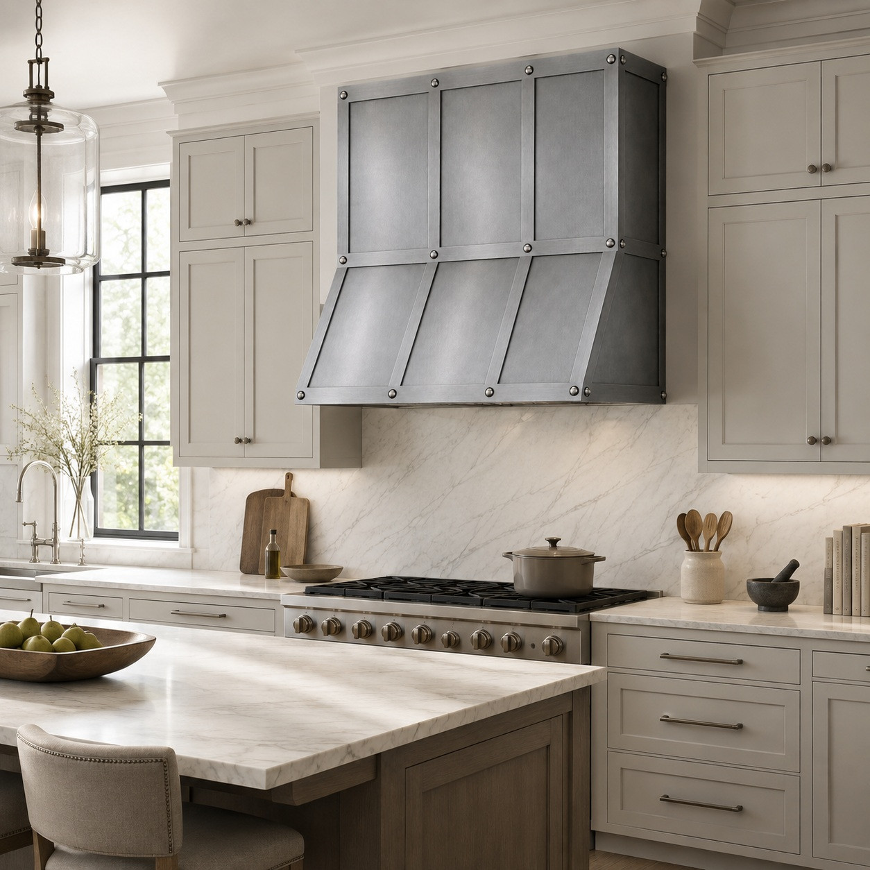 Modern transitional kitchen with zinc range hood, riveted three-bay front, and clean cabinetry