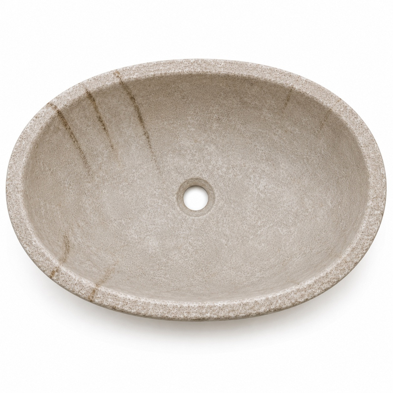 Close view of oval cantera stone vessel sink drain area with carved bowl and natural porous texture