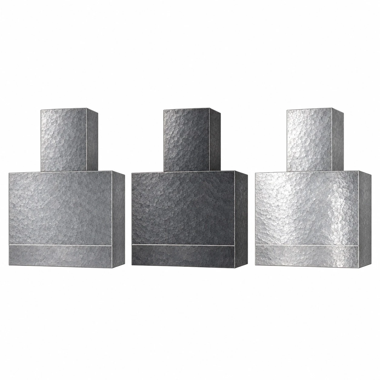 Three hammered zinc range hoods side by side in natural gray, darkened charcoal and bright hand-polished finishes