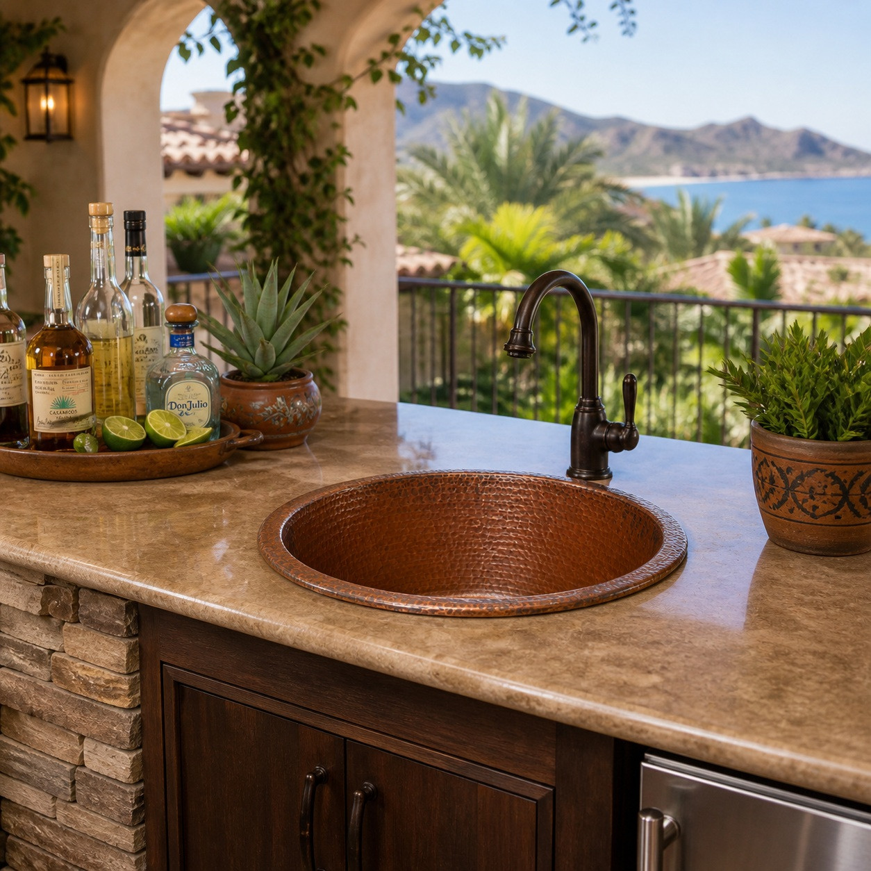Round hammered copper cooler sink installed in outdoor veranda bar with stone countertop and mountain view