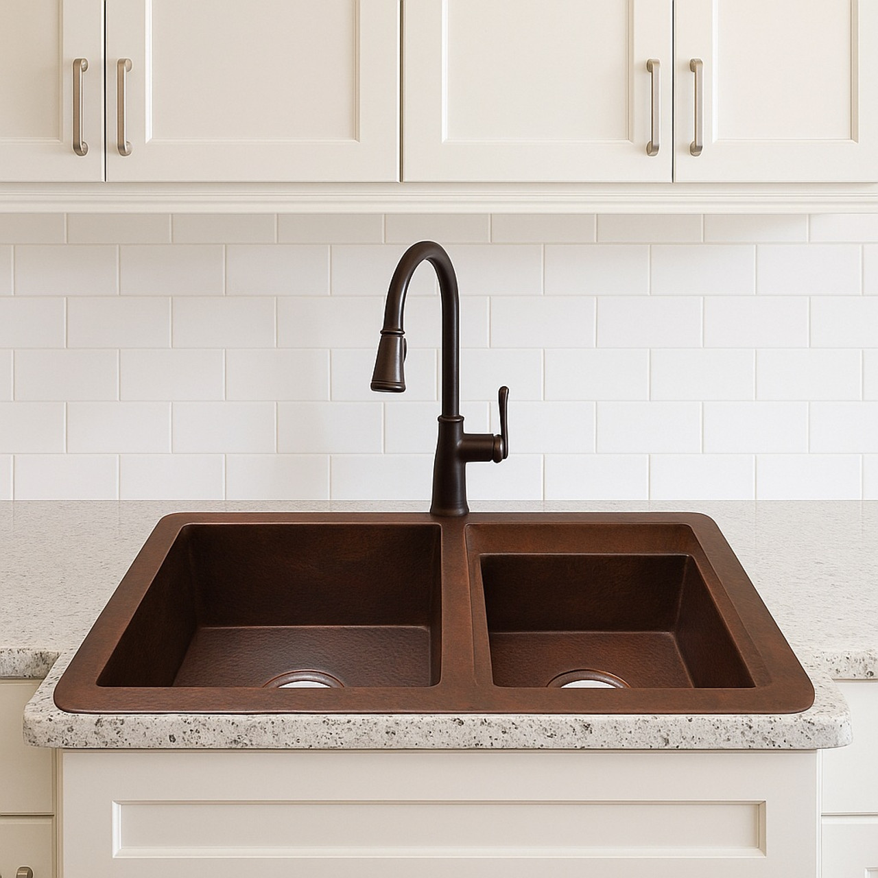 Double copper sink with large and small bowls installed as drop-in in a transitional style kitchen