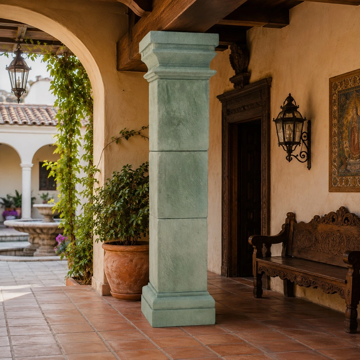 Square cantera stone column with stepped base in a Spanish colonial patio with arches and clay tile