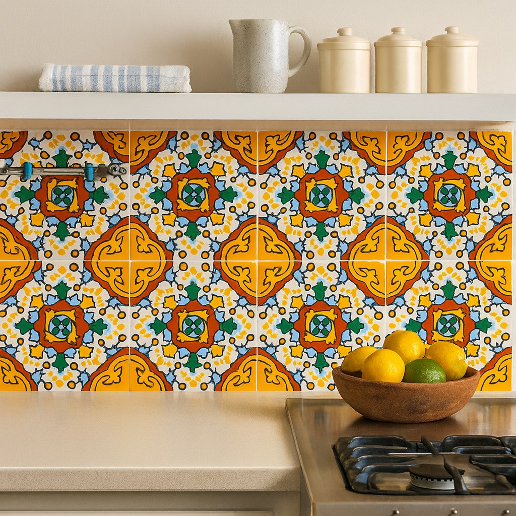 Yellow red medallion talavera tile installed on a kitchen wall backsplash adding color and artisan warmth