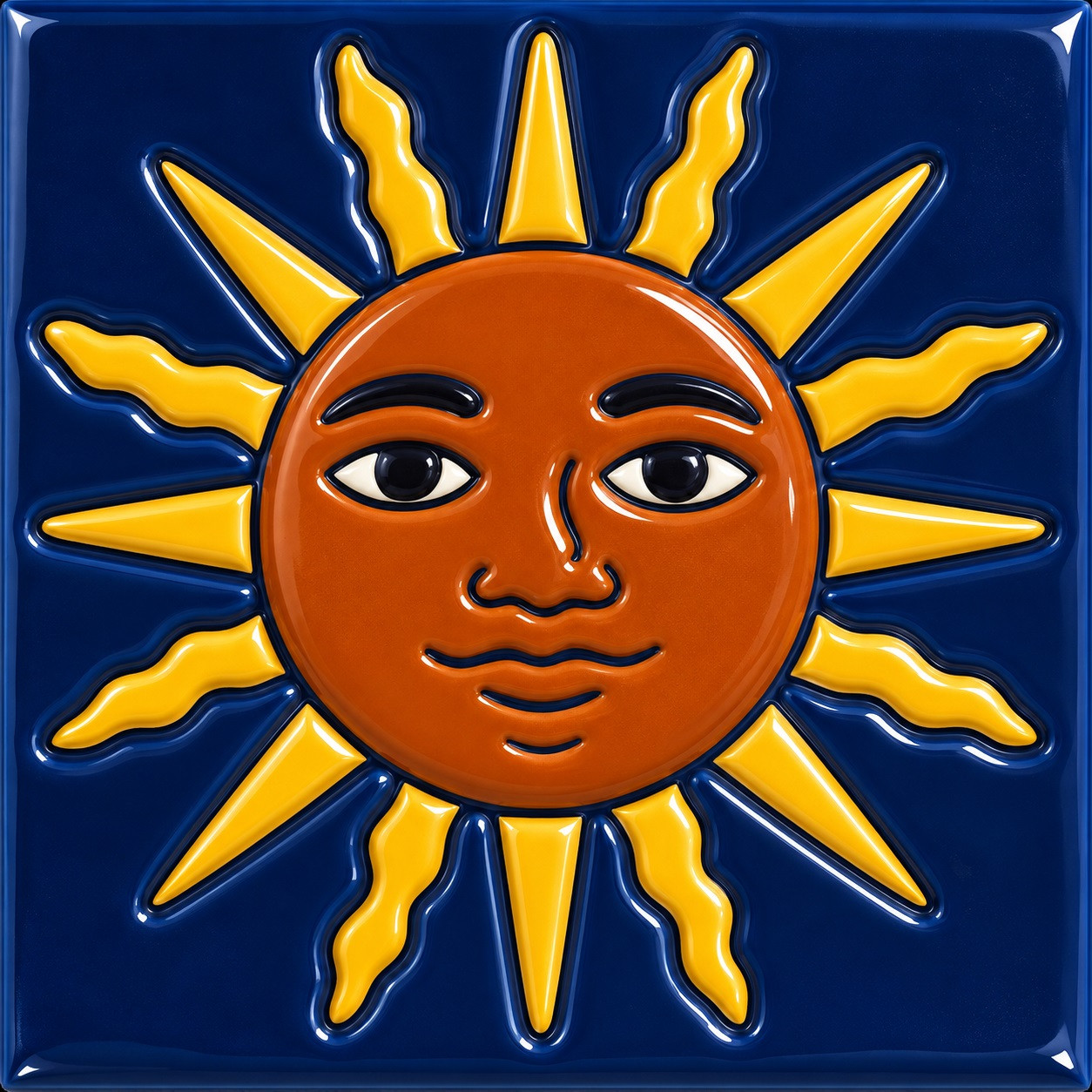 Mexican relief tile with a sun face motif