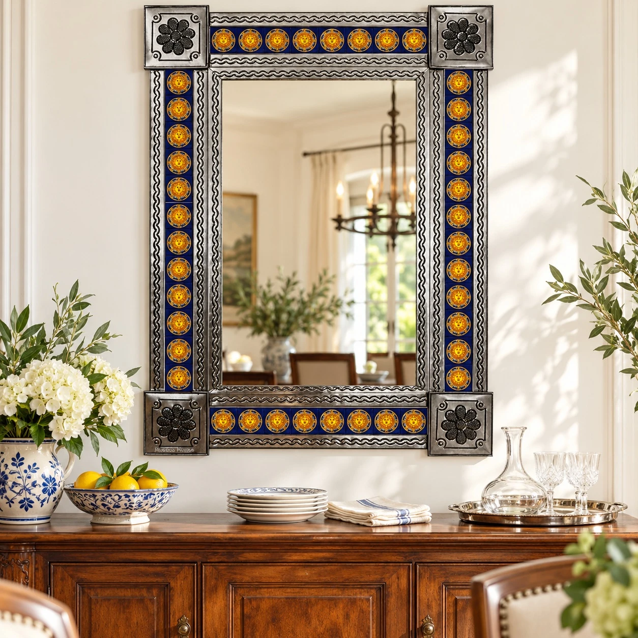 Cobalt blue and yellow Sun Talavera tile mirror above dining room buffet with wood furniture and warm decorative accents