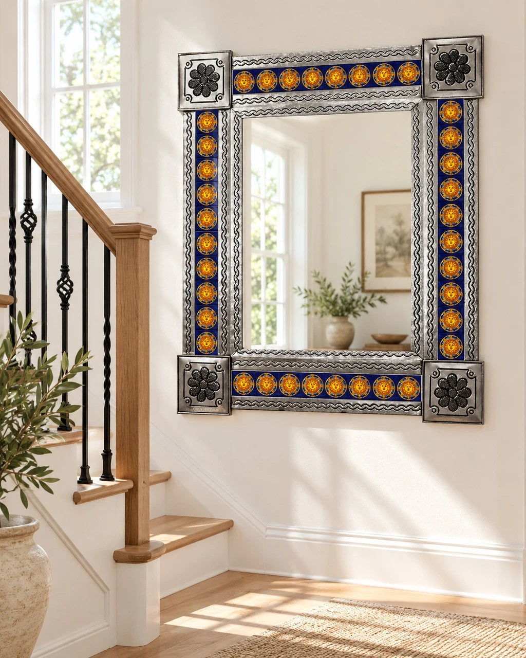 Cobalt blue and yellow Sun Talavera tile mirror on staircase landing with plaster walls, wood railing, and warm flooring