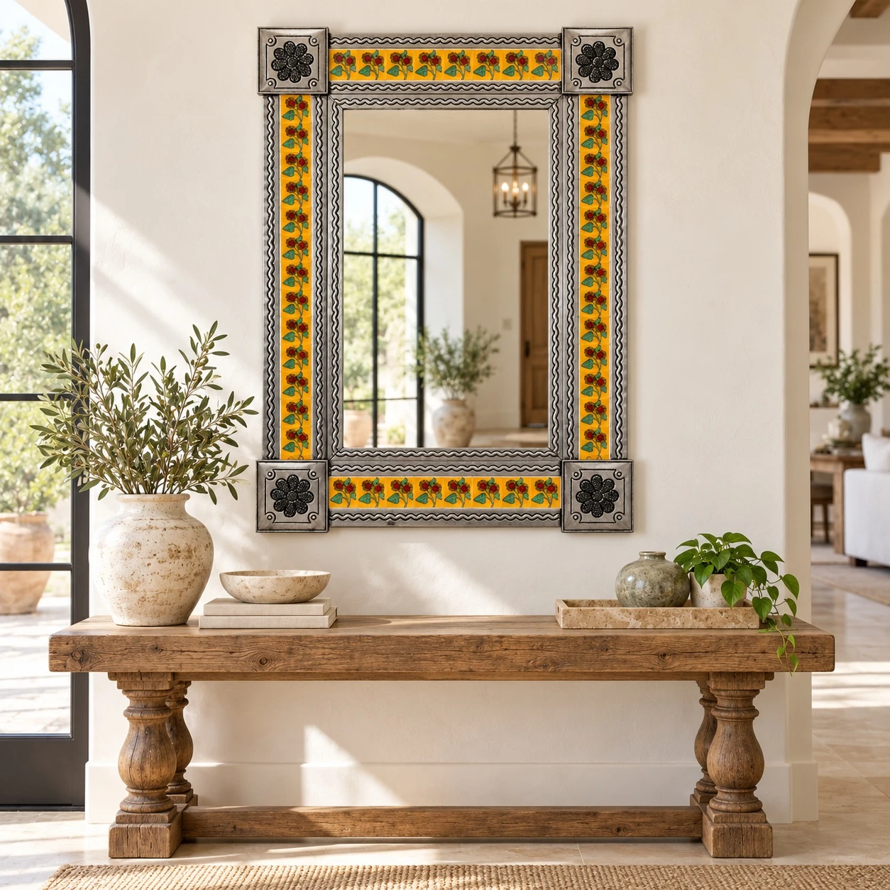 Yellow sunflower Talavera tile mirror above a wood console in a bright Mexican-inspired entryway