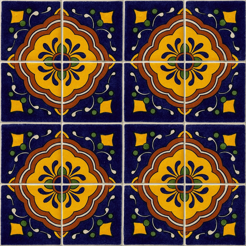 Mexican talavera tile yellow medallion arranged in a 16-tile set with visible light grout divisions