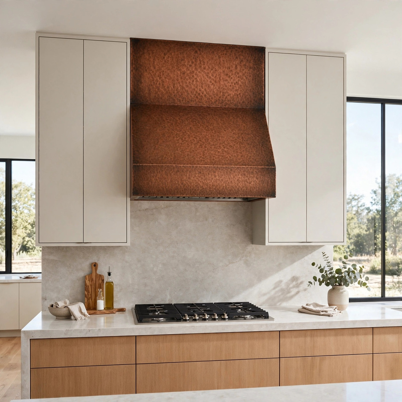 Transitional kitchen with wide-chimney under-cabinet copper range hood between flat-panel cabinets and quartz counter