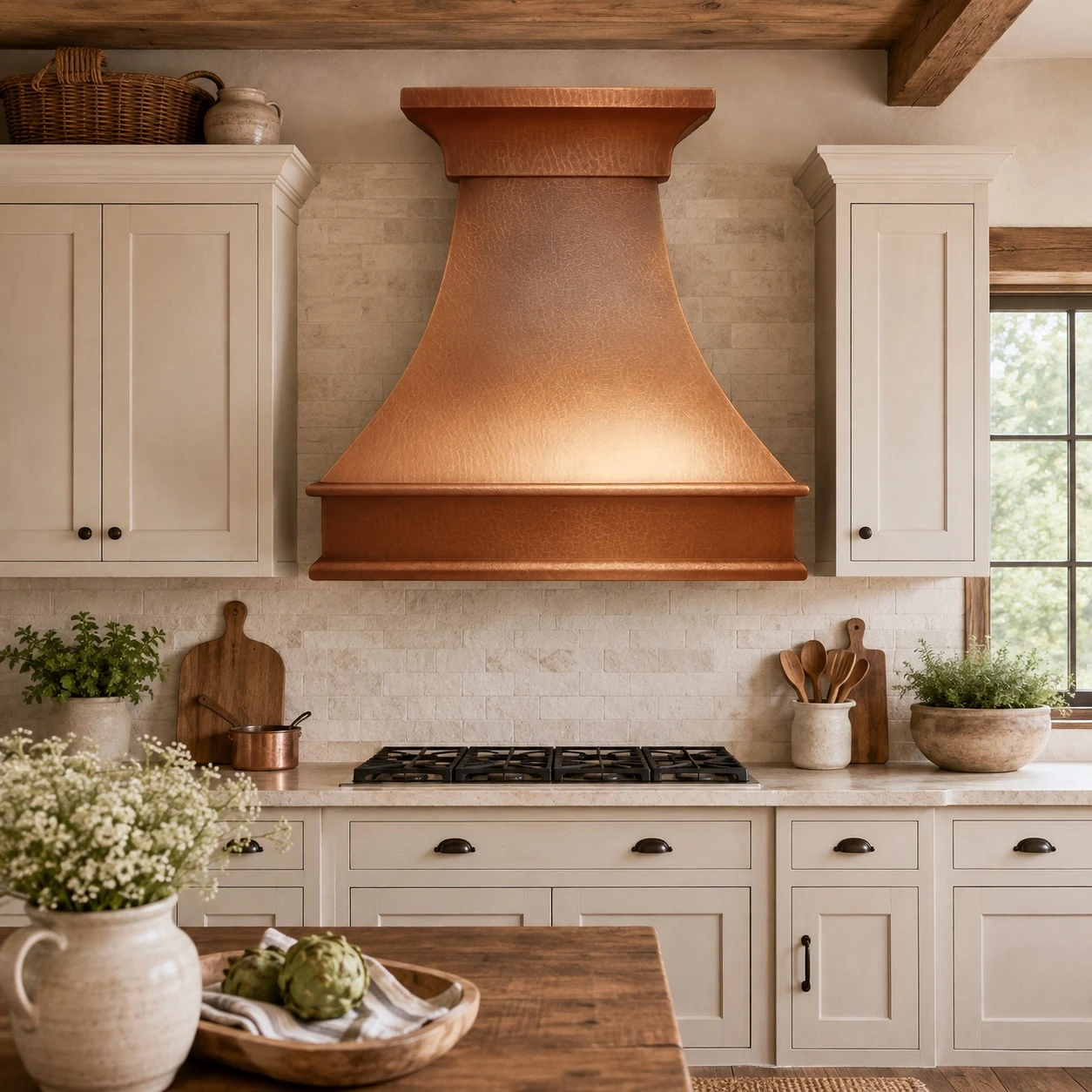 Rustic kitchen copper range hood in a farmhouse kitchen with warm wood and stone accents