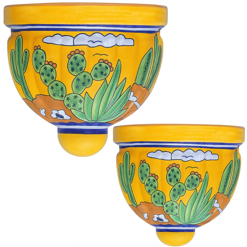 Two Mexican talavera wall sconces with cactus and yellow desert design on white