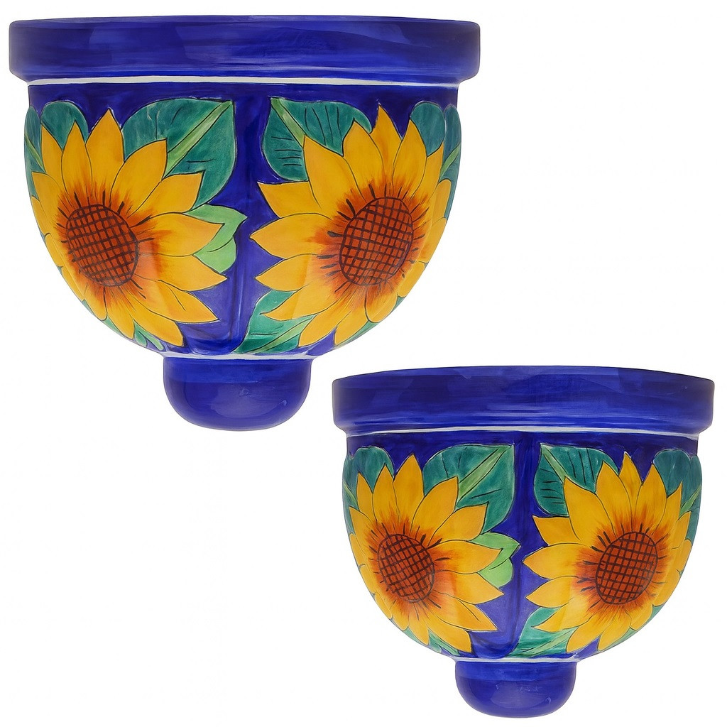 Two Mexican talavera wall sconces with sunflower and cobalt blue design on white