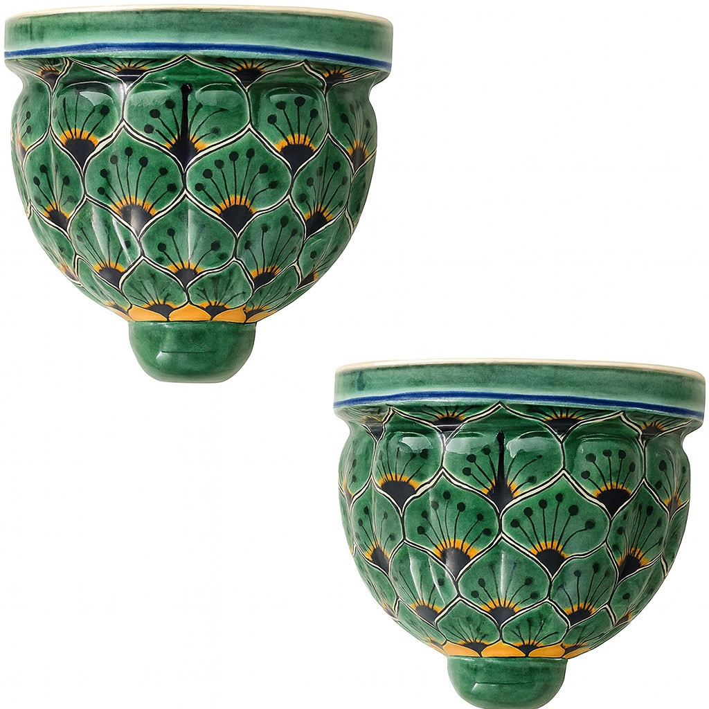Two Mexican talavera wall sconces with green petal pattern shown on a white background