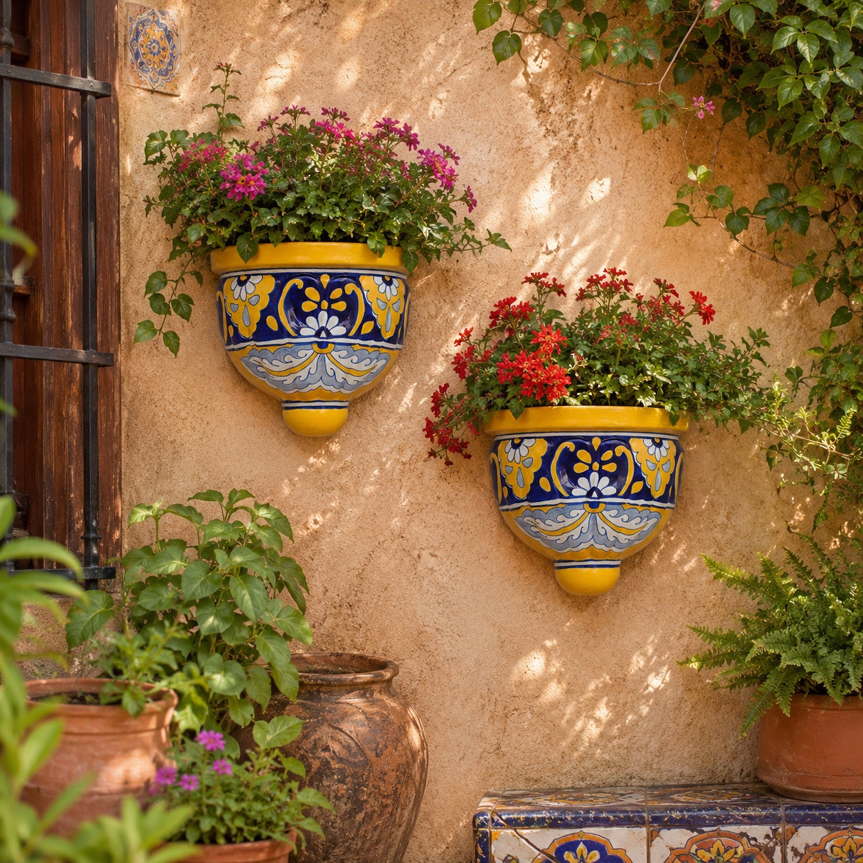 Yellow and cobalt wall sconces with flowering plants displayed on a sunny garden wall
