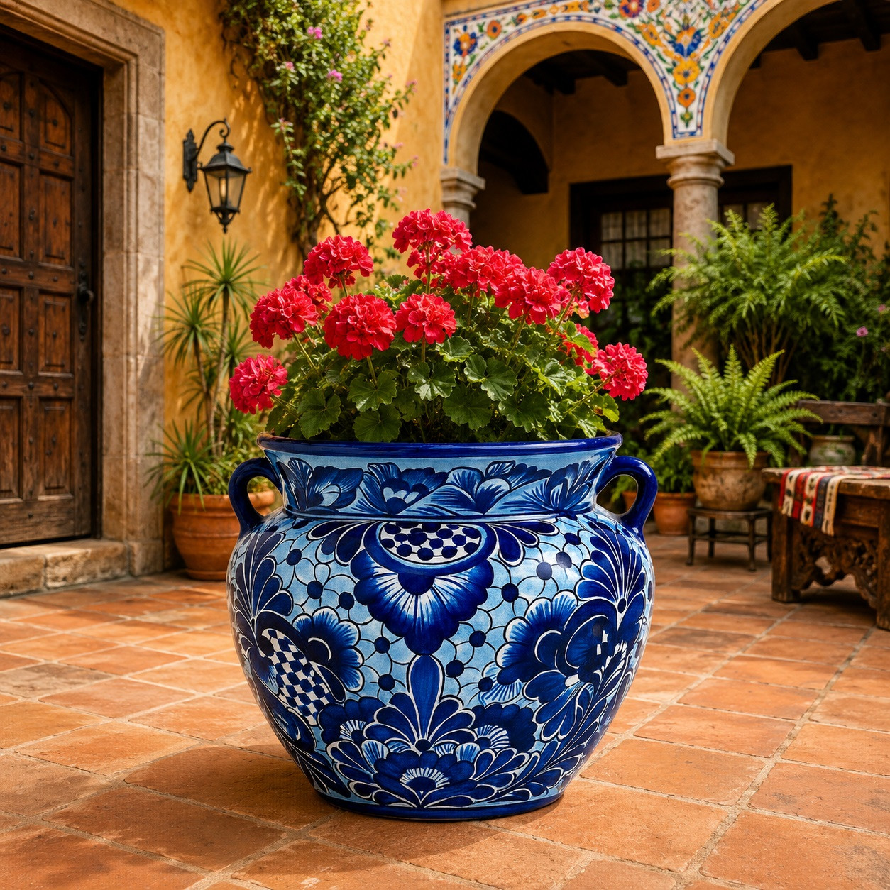 Blue and white Talavera pot filled with lush plants in a colorful Mexican courtyard