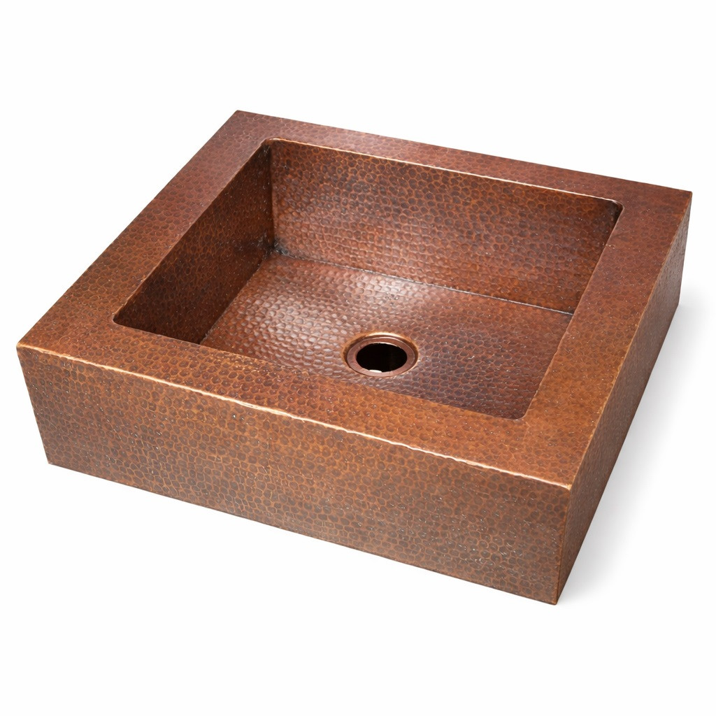 Side view of over-the-counter hammered apron copper bar sink