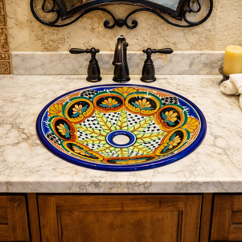 Round talavera bathroom sink floral starburst design set in Mediterranean vanity with marble and bronze fixtures
