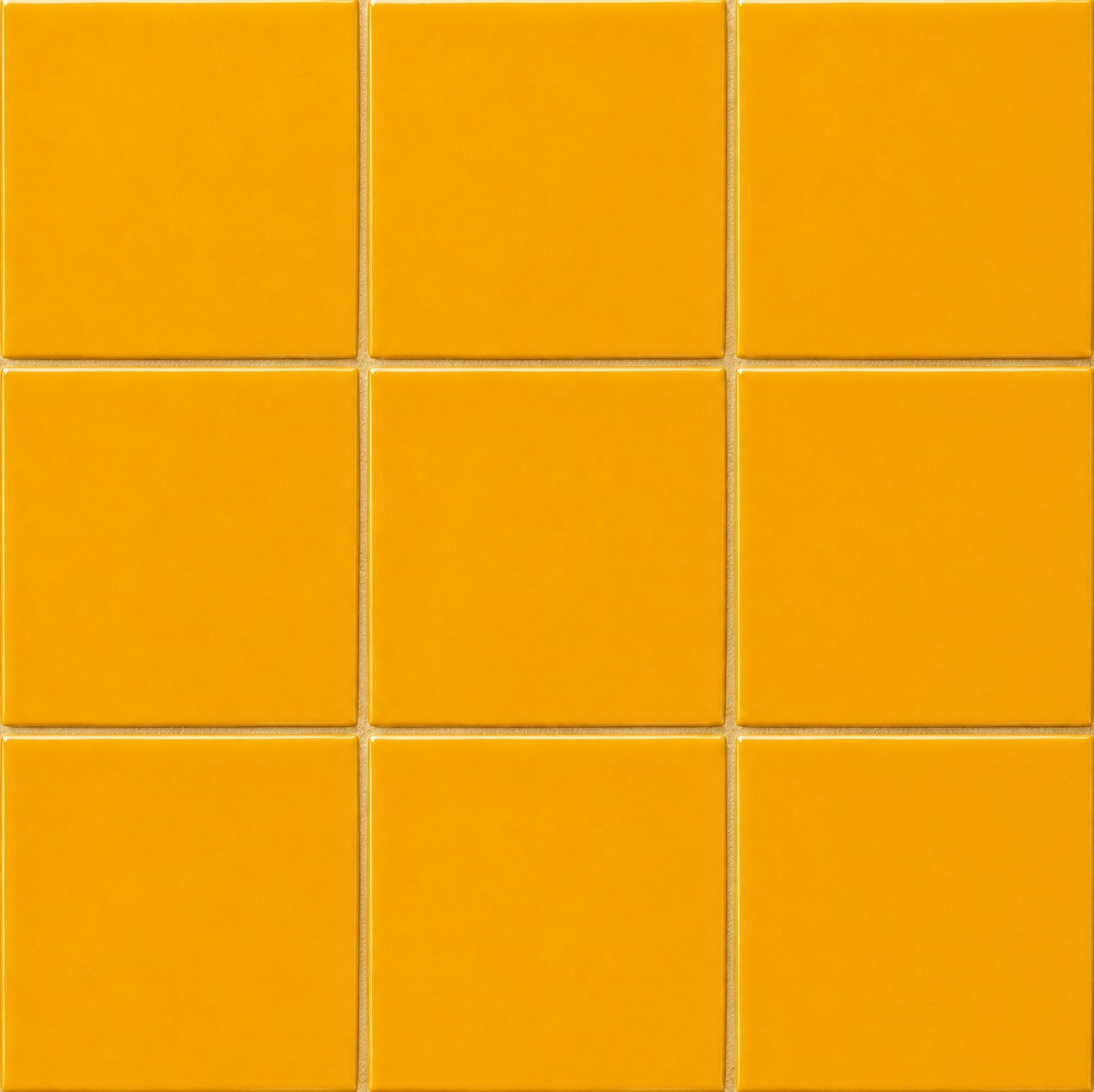 Handmade solid yellow Mexican talavera tiles for warm vibrant interiors shown in a classic 3x3 tile layout