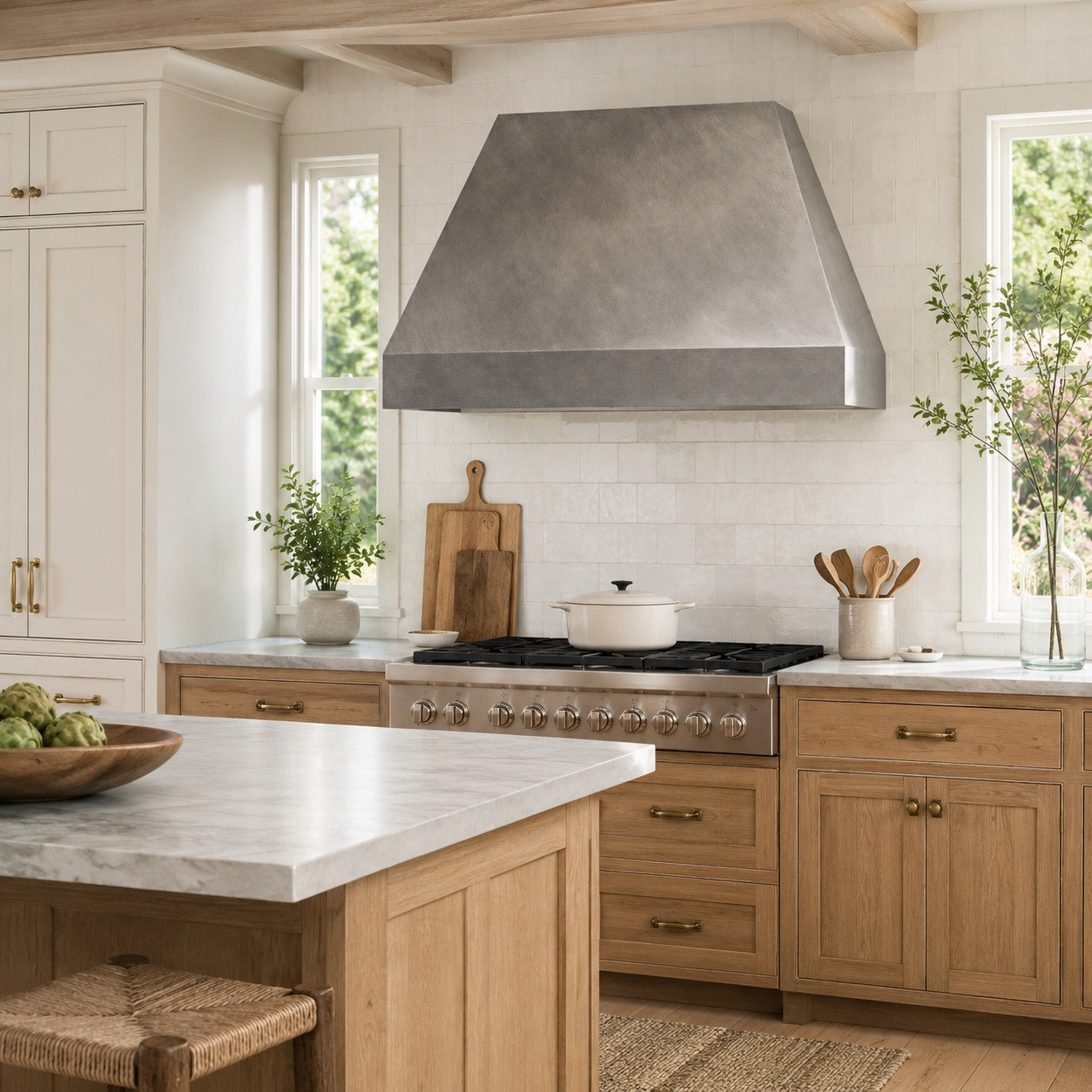 Farmhouse kitchen with minimalist hammered zinc range hood, tapered body, and soft gray finish
