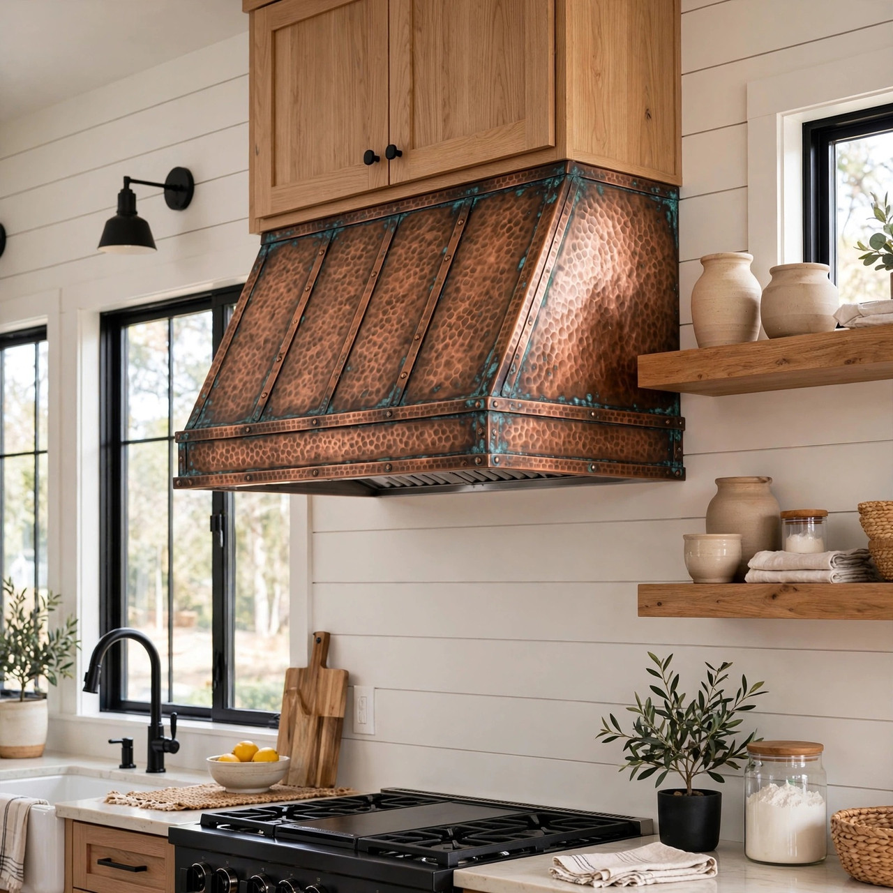Hand-hammered copper hood with vertical straps, oxidized patina in modern farmhouse kitchen with shiplap