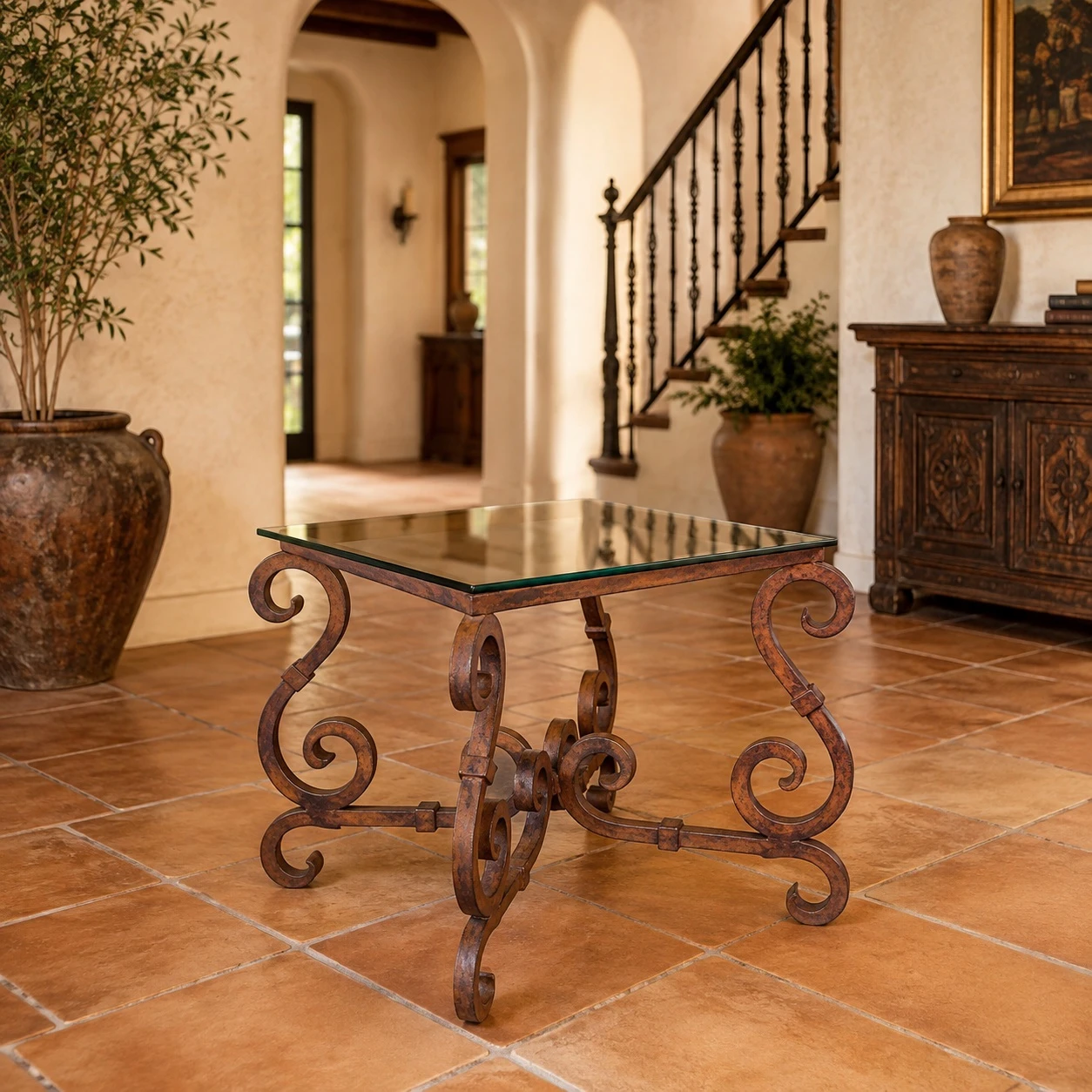 Wrought iron table base with ornate scrolls with glass top in a Spanish-style home