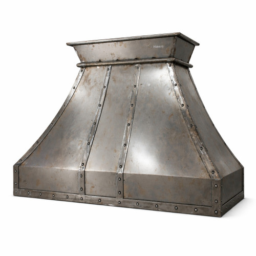 Riveted raw iron range hood with industrial patina side view