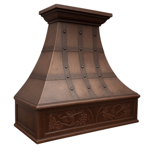 Decorative copper kitchen range hood angled view, hammered copper canopy with dark riveted straps and fruit motif