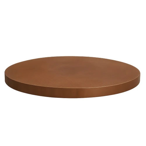Handcrafted round copper dining table top side view, visible edge thickness with hammered surface and light patina
