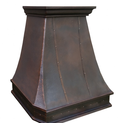 Side view of a vintage hammered copper range hood with antique brown patina