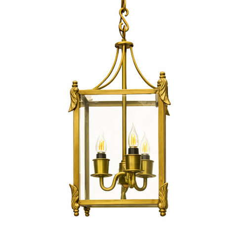 Brass ceiling lantern with classic rectangular design shown front view, symmetrical framed glass panels with straight edges and top loop mount