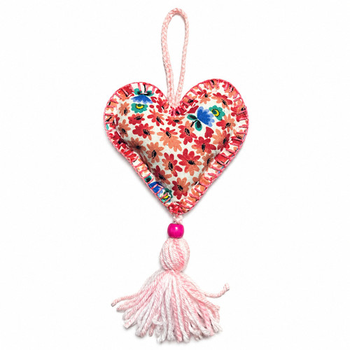 Handmade Floral Mexican Heart Ornament with Pink Tassel featuring colorful floral fabric and blanket stitching on white background