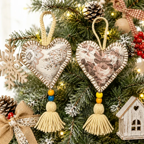 Handmade floral fabric heart ornaments hanging on farmhouse Christmas tree with rustic holiday décor