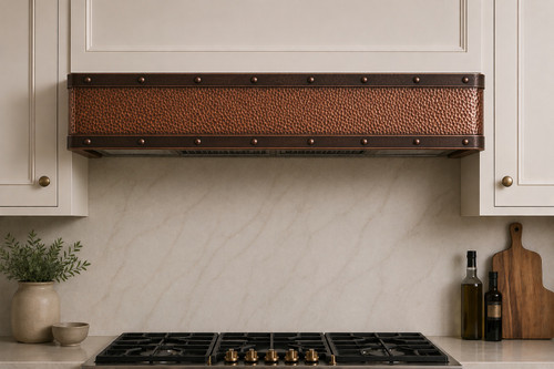 Hammered copper under cabinet range hood with dark bronze straps and rivets cluse up