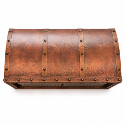 Soft-hammered under-cabinet copper range hood with antique patina, curved canopy, riveted straps and white background