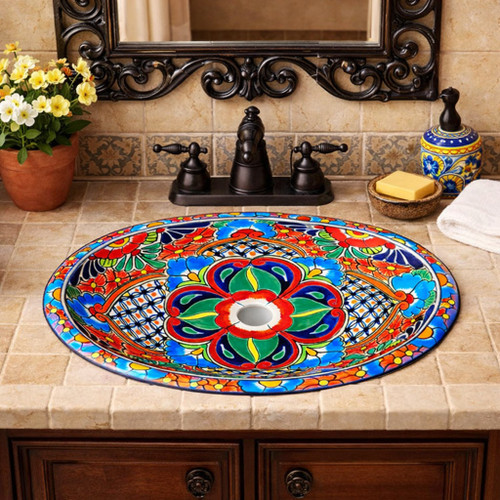 Oval talavera floral geometric mexican bathroom sink in Spanish Revival vanity with carved wood cabinet and iron mirror