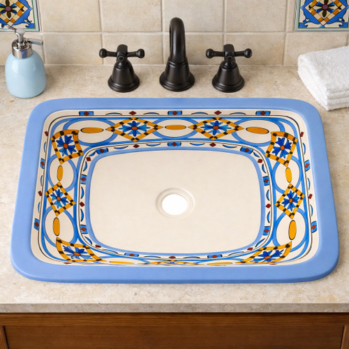 Rectangular talavera bathroom sink blue geometric pattern design installed in traditional house bathroom with wood vanity