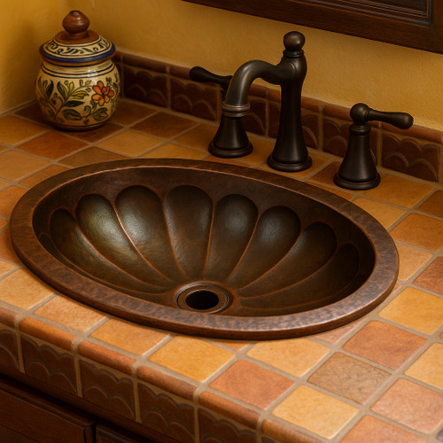 Hammered fluted copper bathroom sink featured in a Spanish Revival bathroom with warm handcrafted finishes