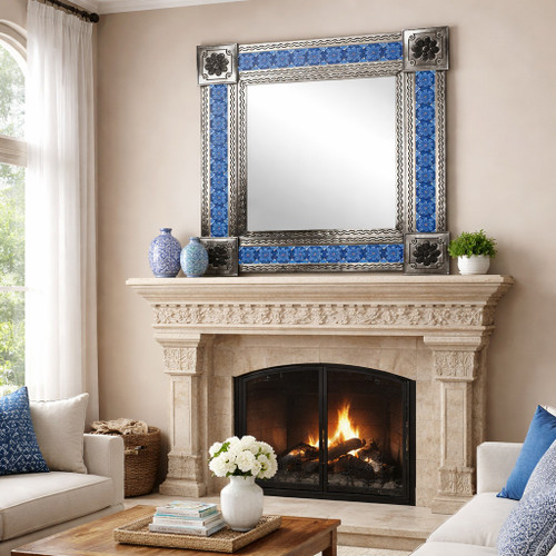 Rectangular Talavera tile mirror with blue white floral pattern above stone fireplace in living room, natural frame and ceramic border reflecting space