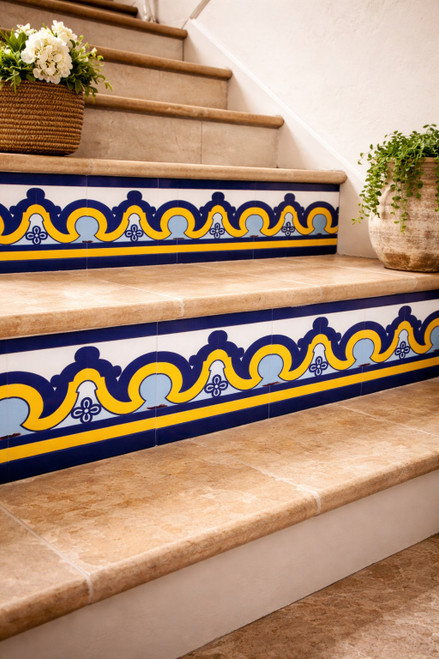 Talavera tile cobalt arch border with yellow accent featured on a stair riser with traditional character