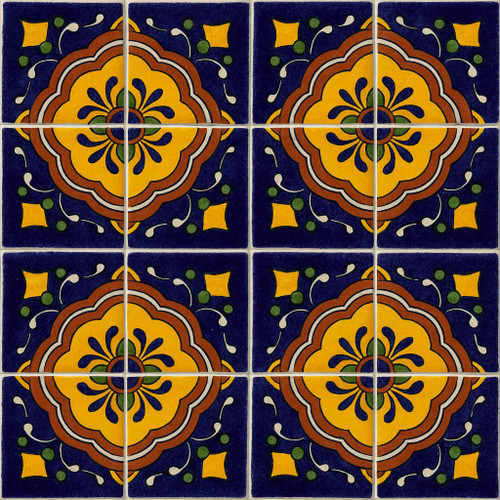 Mexican talavera tile yellow medallion arranged in a 16-tile set with visible light grout divisions