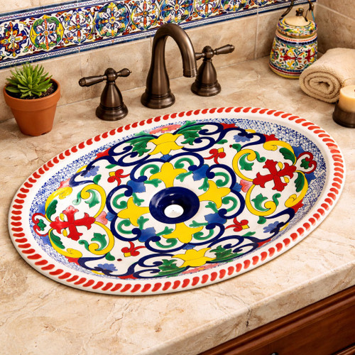 Mexican talavera scrollwork hand painted bathroom sink featured in a bathroom with tile walls and stone vanity