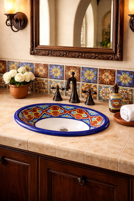 Talavera cobalt terracotta bathroom sink placed in a Spanish Revival space with plaster walls and arches