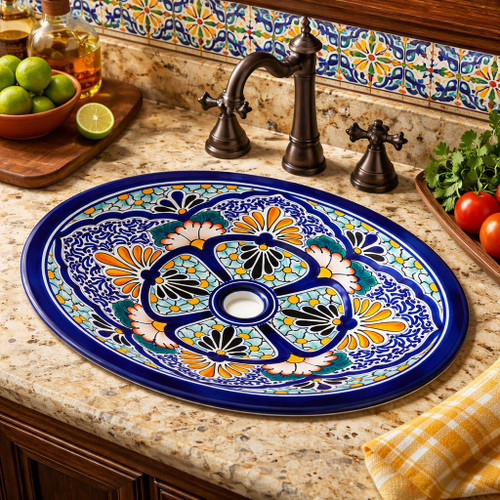 Cobalt floral oval talavera bathroom sink installed as accent sink in hacienda kitchen with wood cabinetry